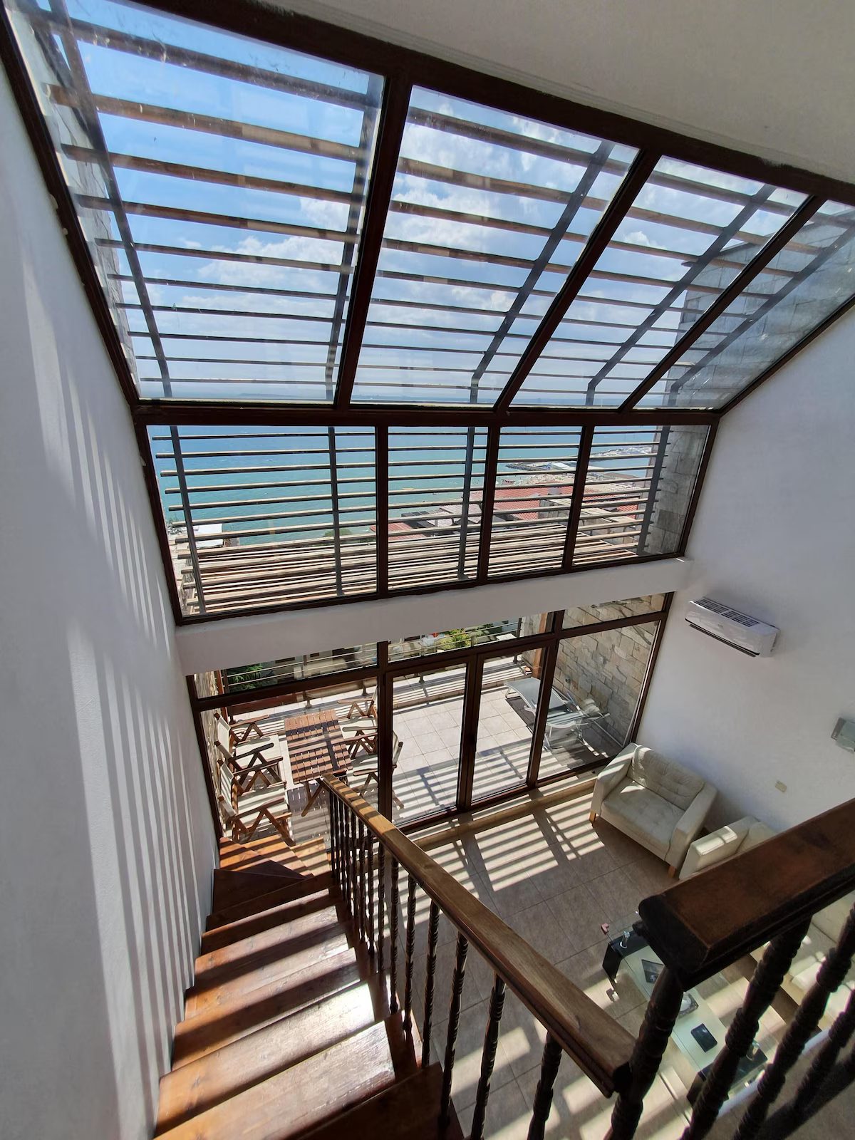 Glass atrium over the stairs, looking down to the terrace