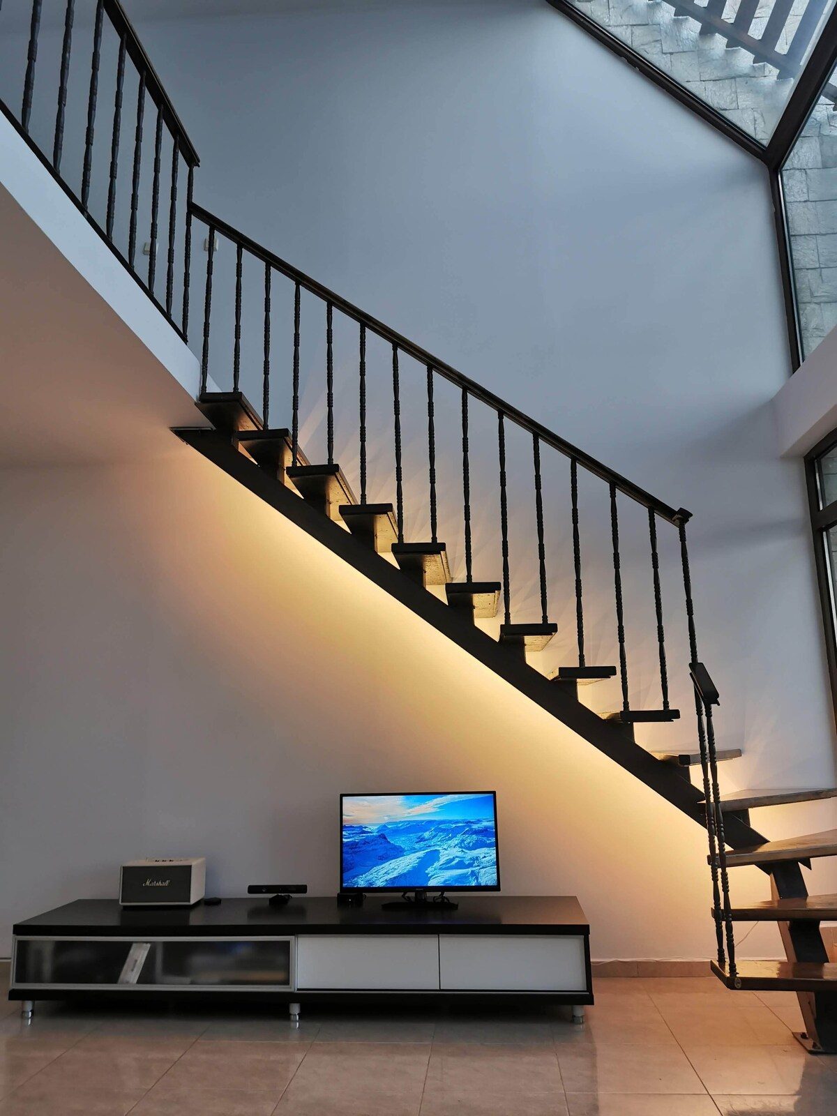 Double-height living space with a floating staircase